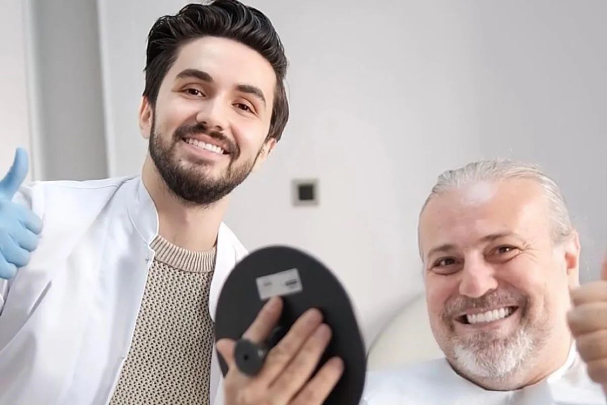 Dentist İbrahim Türker with a patient at his practice