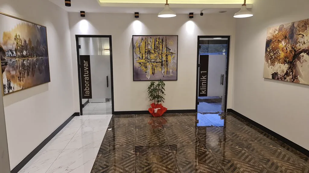 Interior corridor and treatment-room entrances at Dt. Kadir Şahin Dental Practice