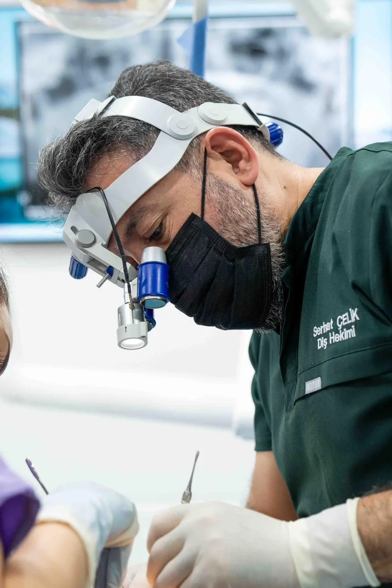 Dt. Serhat Çelik during a dental procedure at the clinic