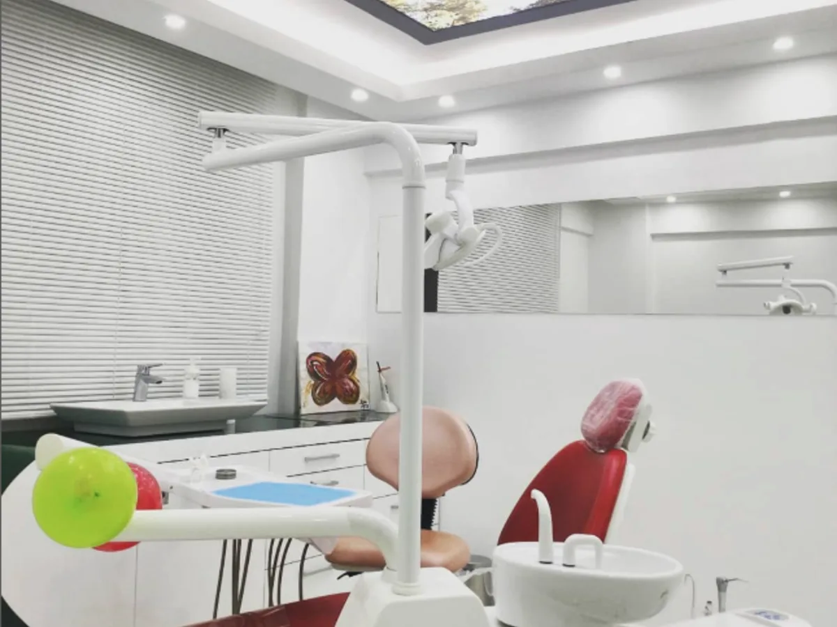 Dent 232 treatment room with a red dental unit