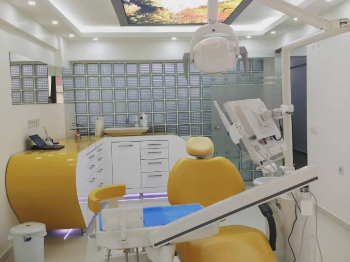 Dent 232 treatment room with a yellow dental unit