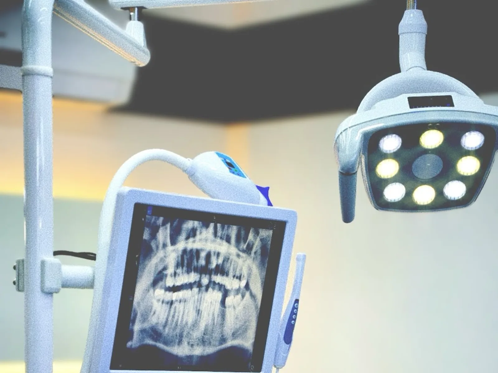 Clinic treatment area with dental imaging screen and treatment unit