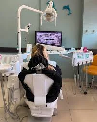 Clinic treatment room with a dental chair and panoramic imaging display