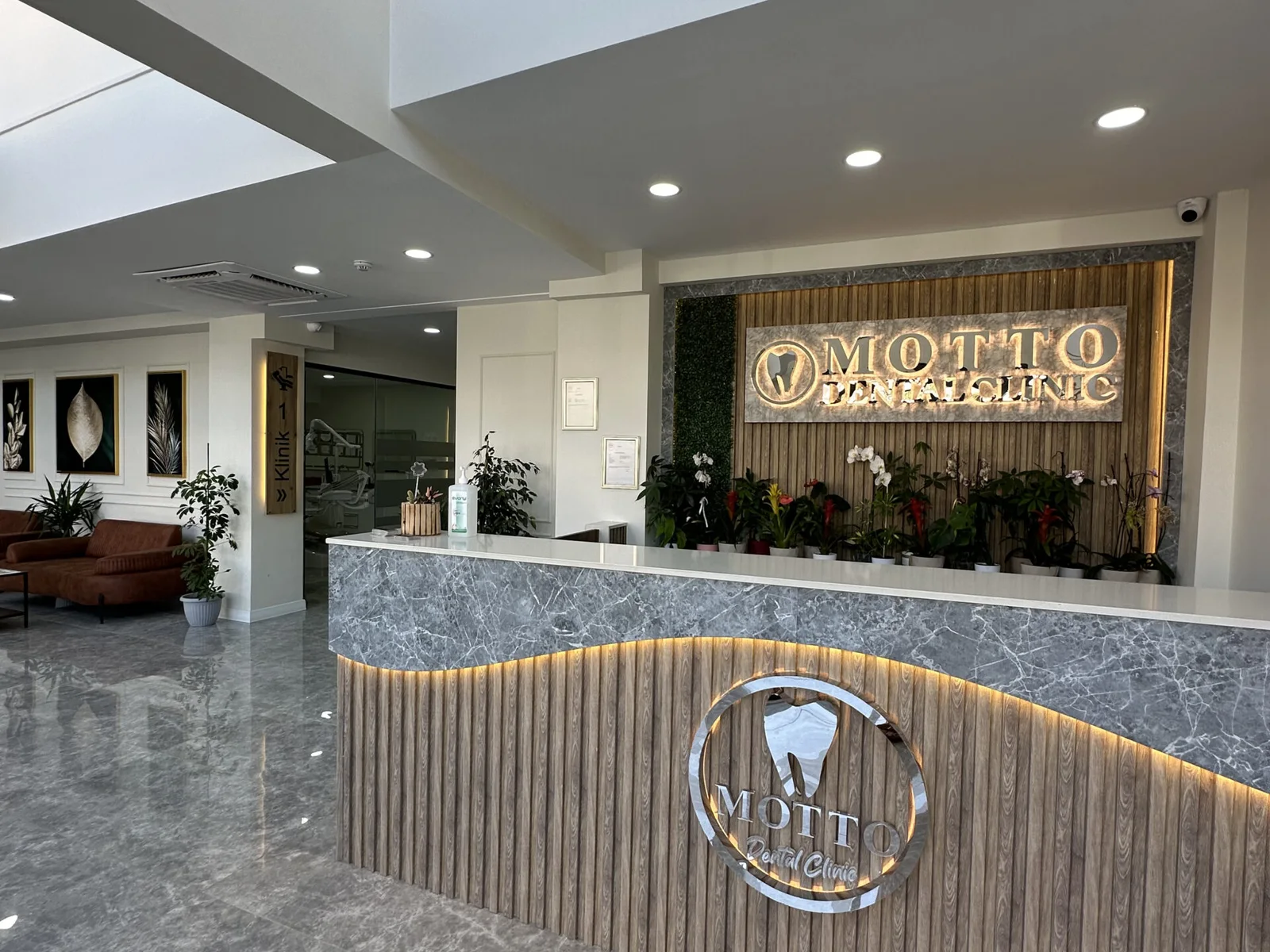 Motto Dental reception desk and illuminated clinic sign