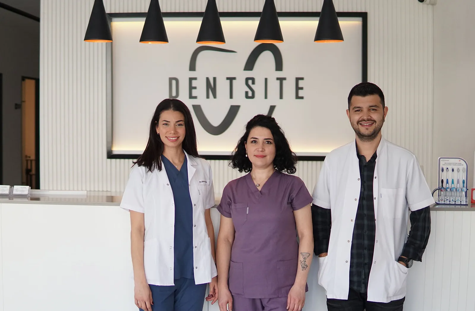 Clinical team in front of the Dentsite branding