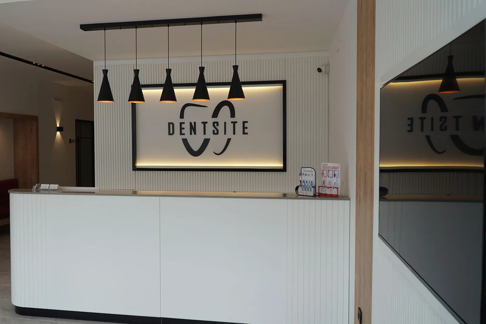 Dentsite reception area with clinic branding