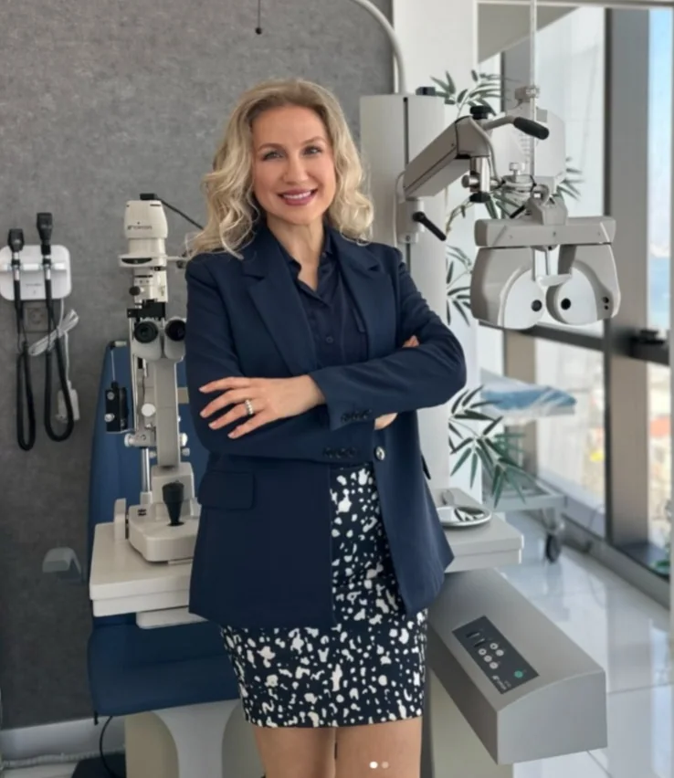 Op. Dr. Şeyda Atabay beside eye examination equipment